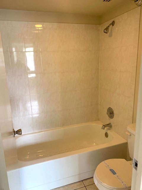 a white bath tub sitting next to a white toilet