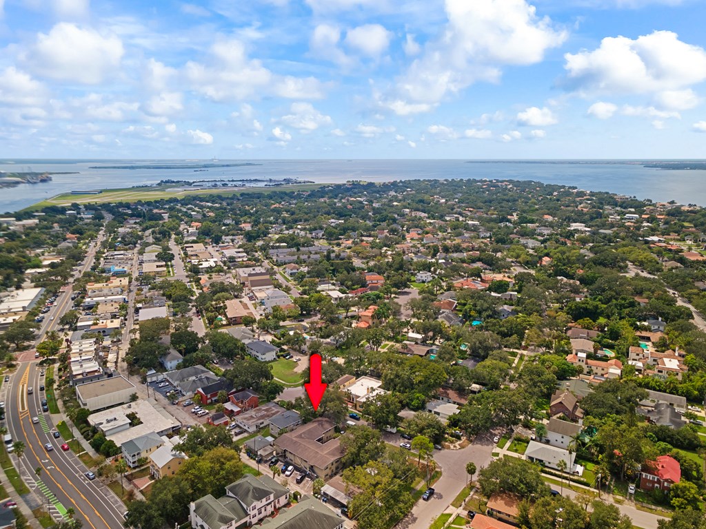 an aerial view of a city with a red marker on it