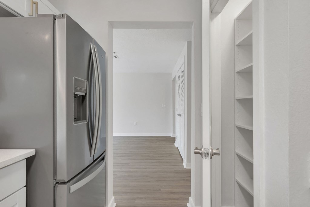 a kitchen and hallway in a 555 waverly unit