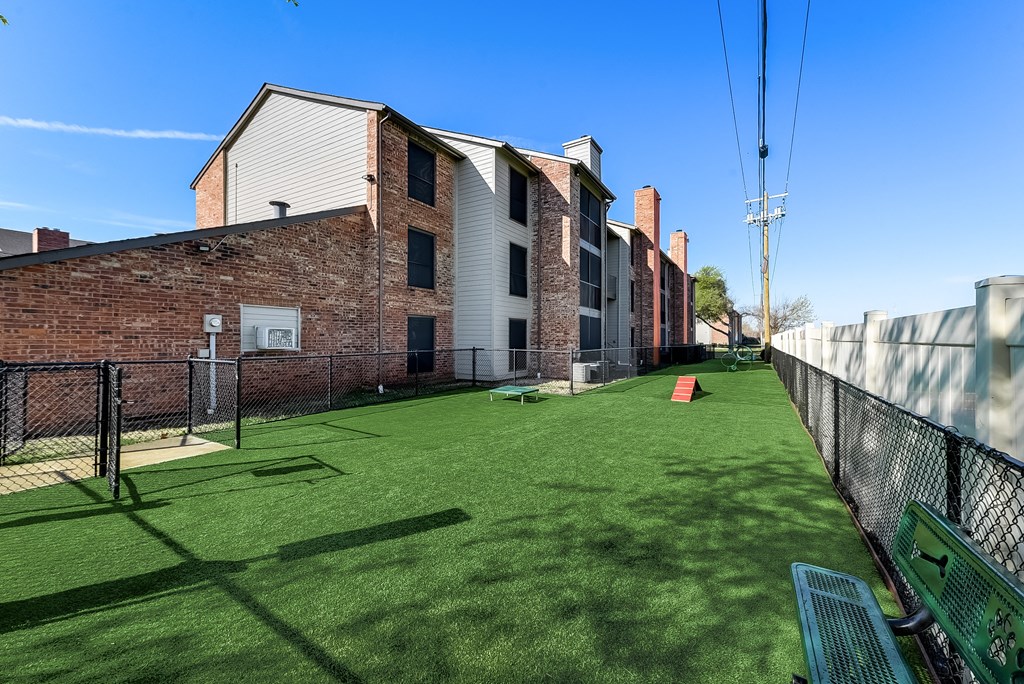 a large fenced in dog park with agility course and agility course