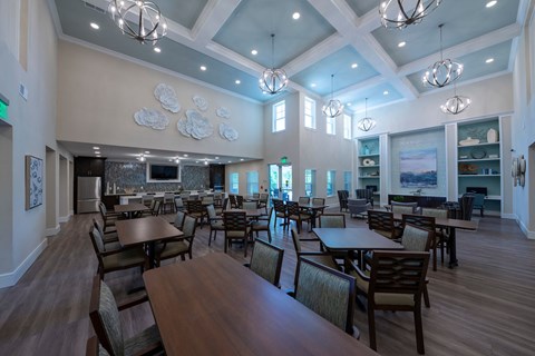 a large dining room with tables and chairs and a fireplace