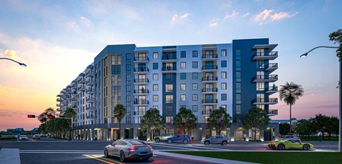 A modern apartment building with cars parked in front.