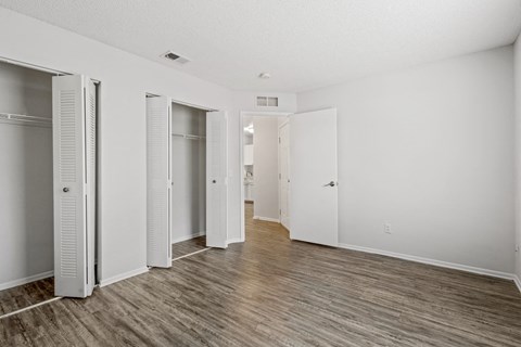 a renovated living room with white walls and sliding closet doors