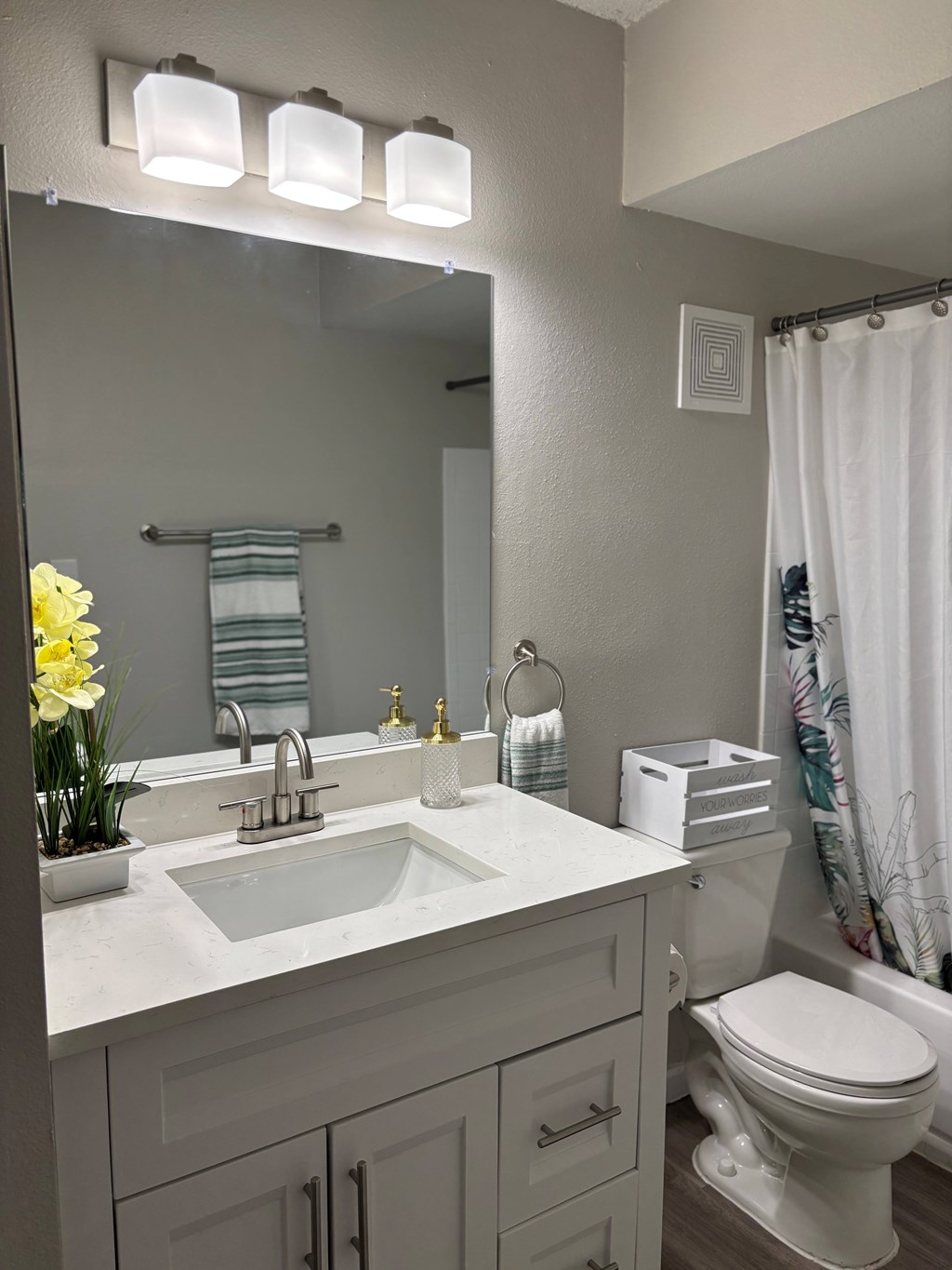 A bathroom with a white sink and toilet.
