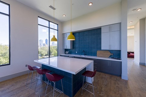 a kitchen with a white counter top and blue tiles