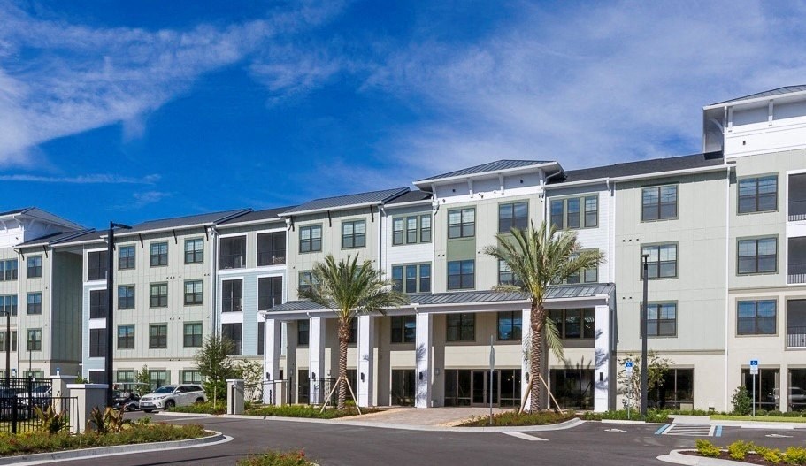 Longleaf Apartments building surrounded by palm trees in St. Johns, FL.