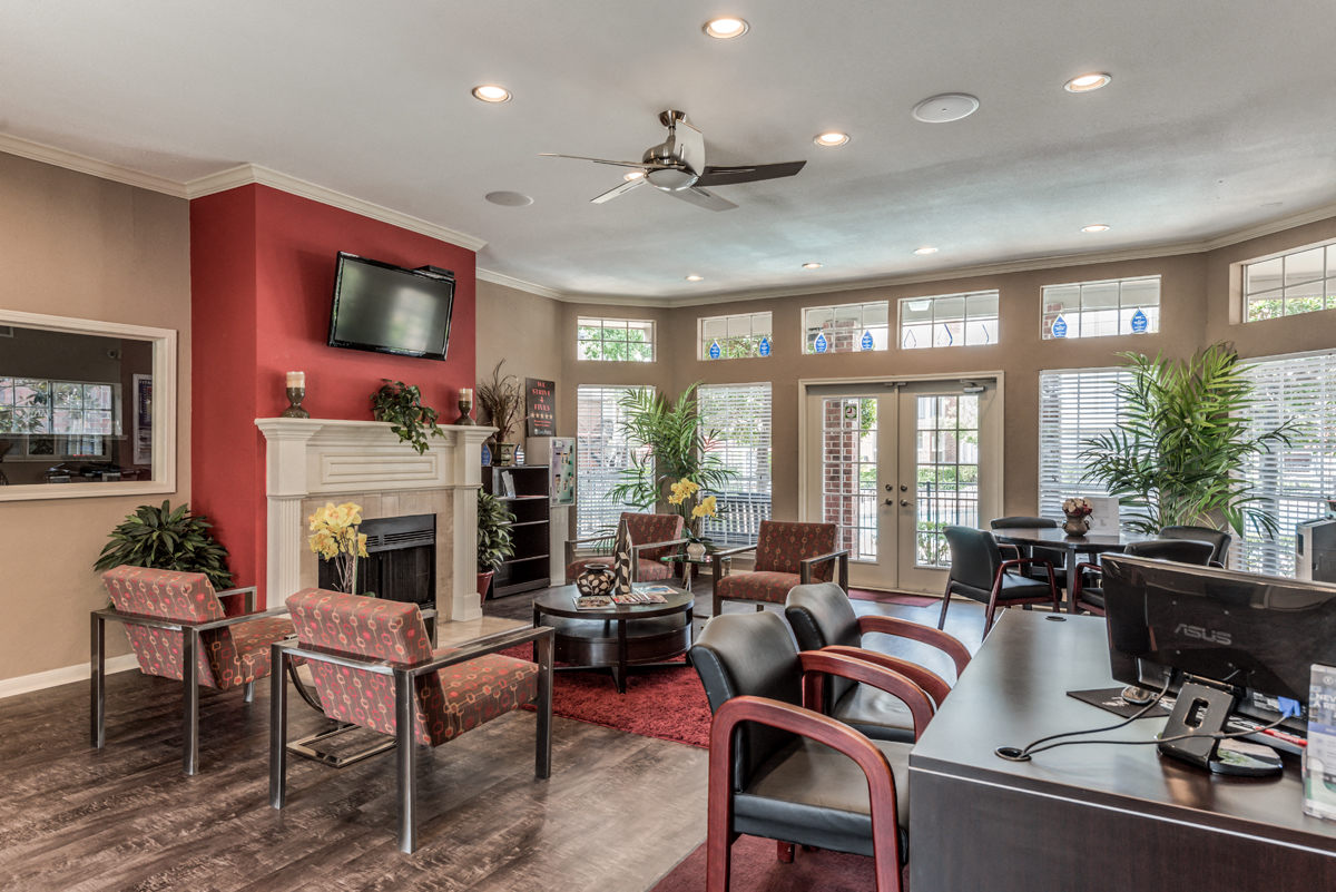 a living room with a fireplace and a table with chairs