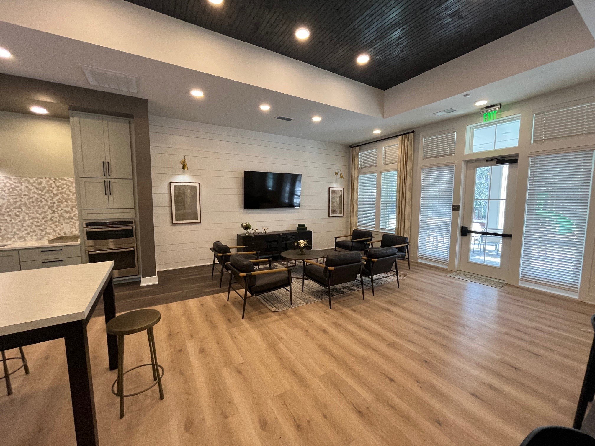 a living room with a tv and a table and chairs
