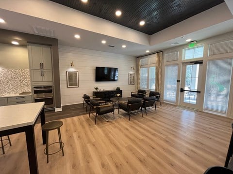 a living room with a tv and a table and chairs