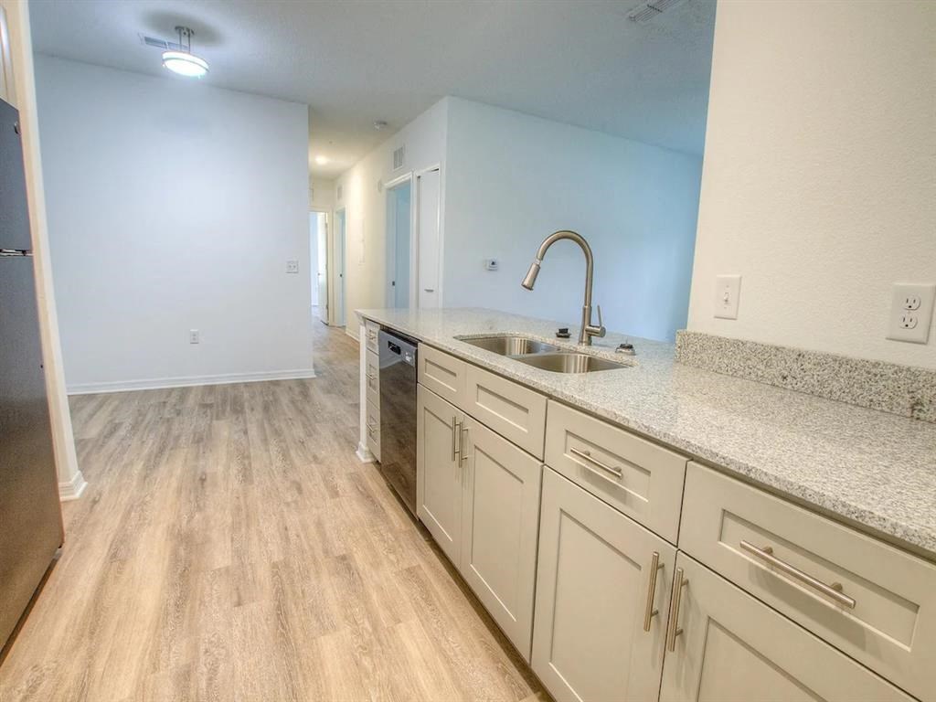 a kitchen with white cabinets and a sink
