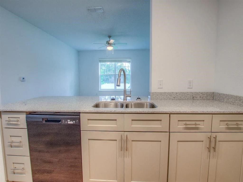 a kitchen with white cabinets and a sink