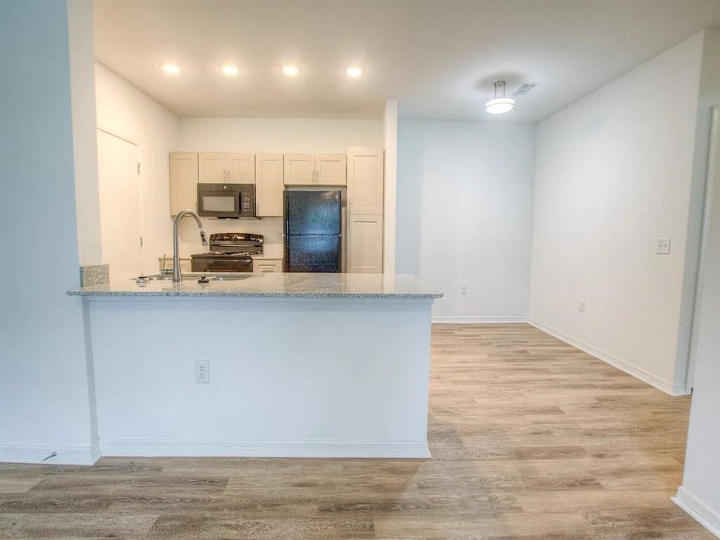 a kitchen with a counter top and a refrigerator