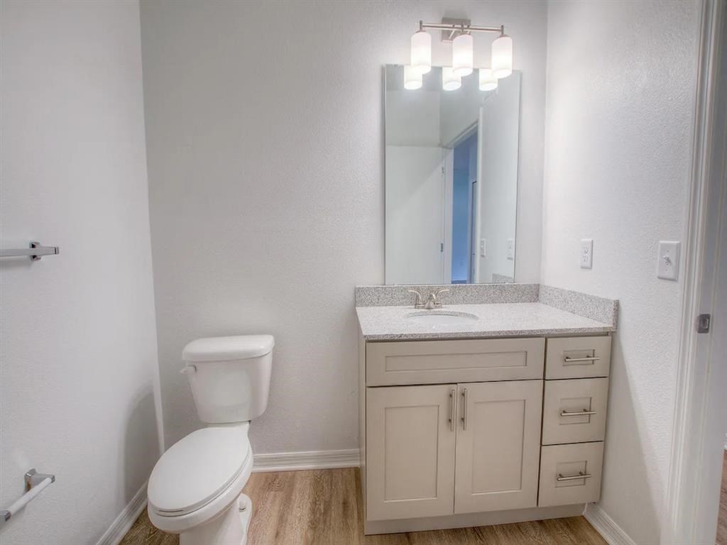 a bathroom with a toilet sink and a mirror