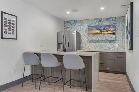 a kitchen with a bar and a painting on the wall