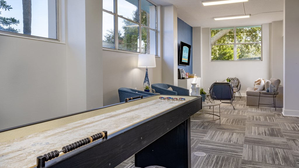 A room with a pool table and a chair.