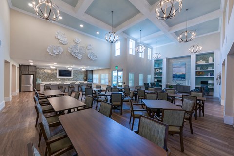 a dining room with tables and chairs and chandeliers