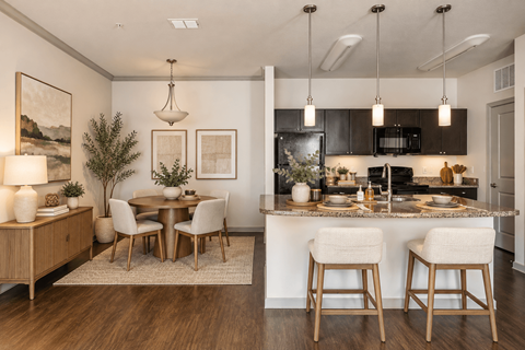 A modern kitchen with a dining table and chairs.