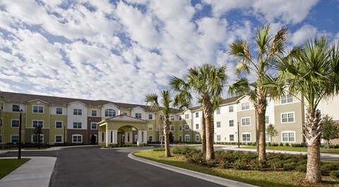 A large building with a driveway in front of it.