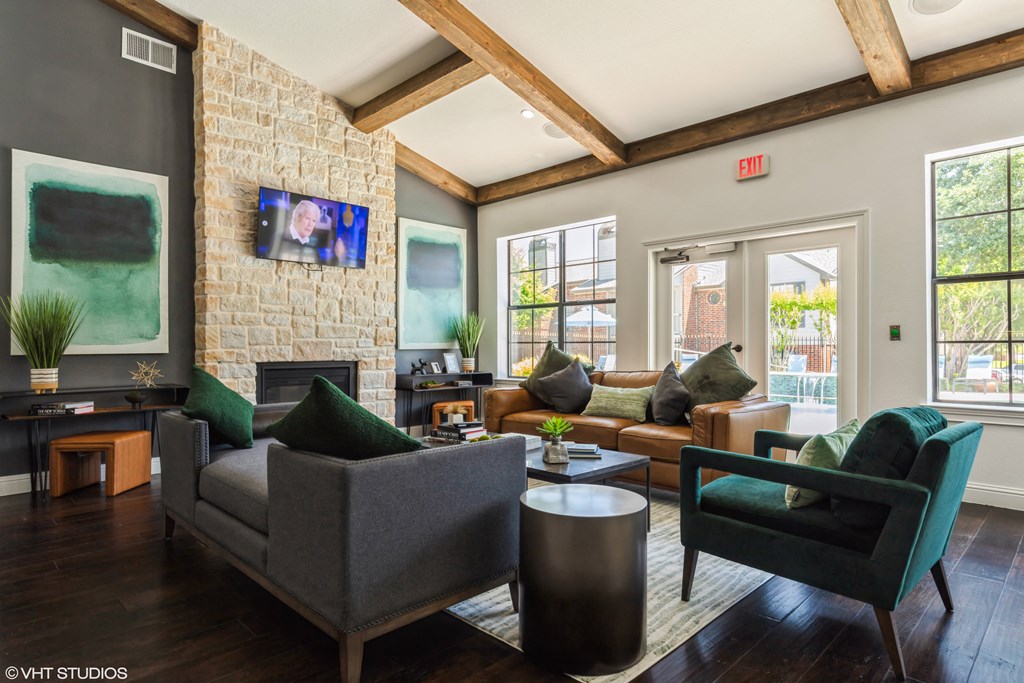 a living room with couches and chairs and a fireplace