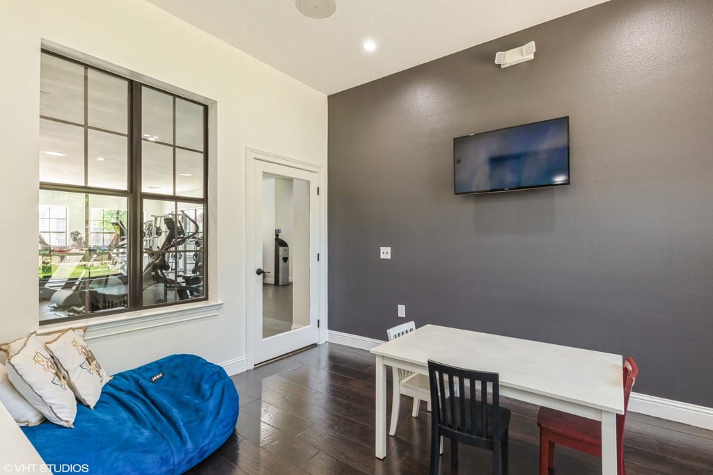 a living room with a couch and a table and a tv