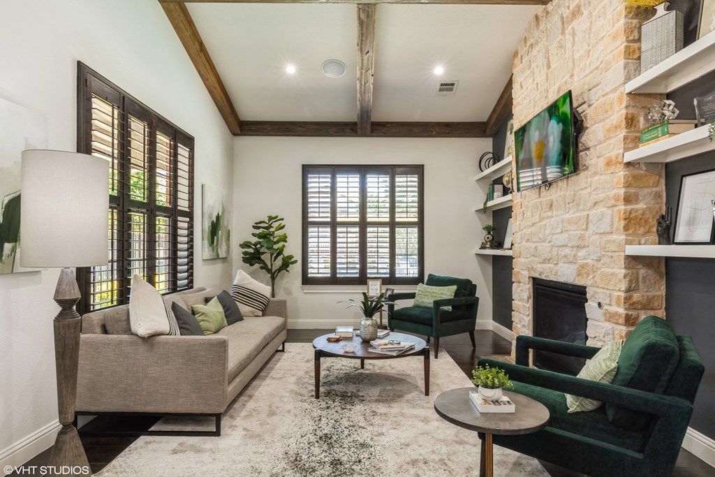 a living room with couches and chairs and a fireplace