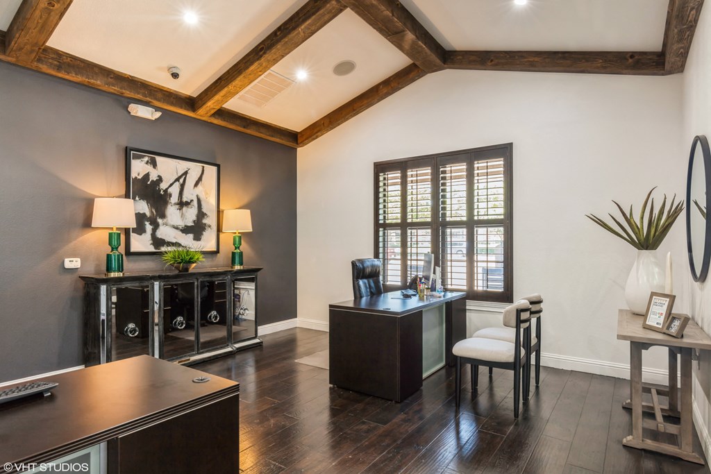 an office with a desk and a chair and a window