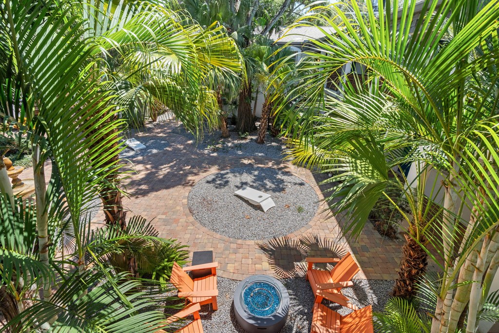 a backyard with a patio and palm trees