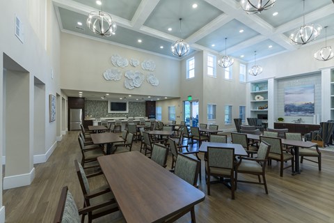 a large dining room with tables and chairs and a fireplace