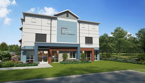 A modern building with a sign that reads "Enclave at Cedarwood".
