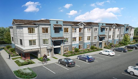 A modern apartment building with a parking lot in front.