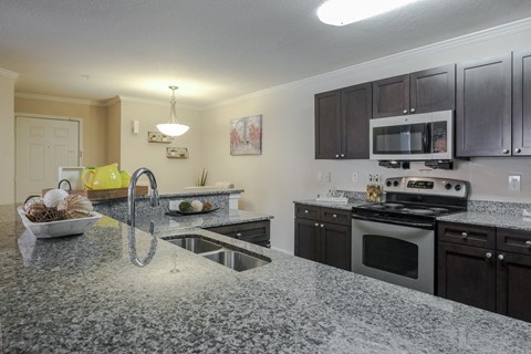 a kitchen with granite counter tops and stainless steel appliances