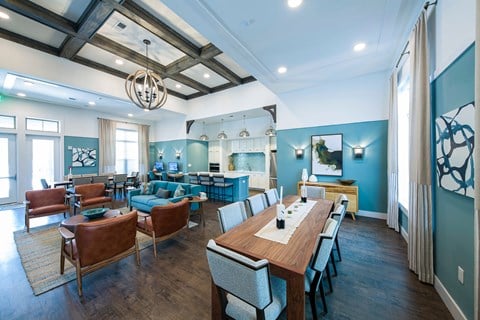 a living room with blue walls and a wooden table and chairs