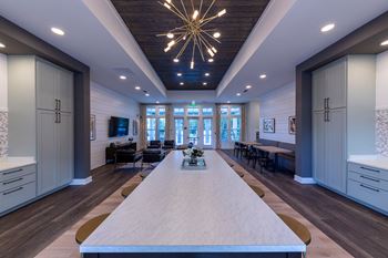 a dining room with a long table and a chandelier