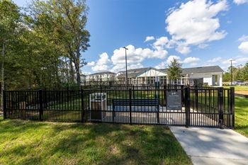 the entrance to a park with a wrought iron fence