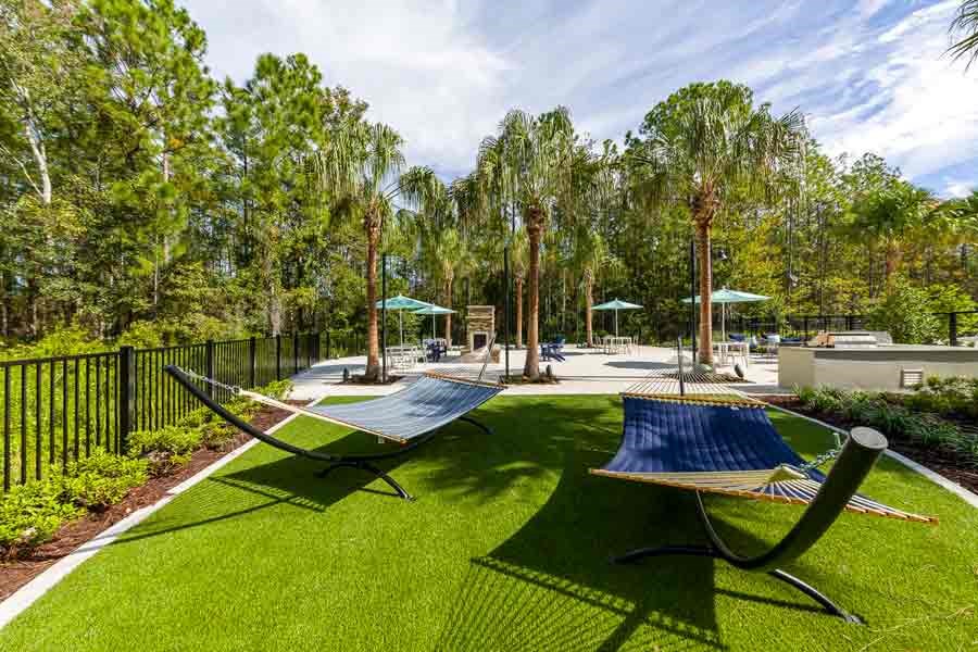 Relaxing hammocks at Longleaf at St. Johns Apartments, St. Johns, FL, surrounded by greenery