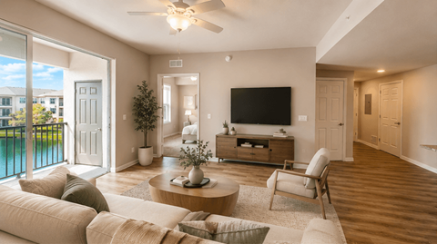 A modern living room with a flat screen TV and a sliding glass door.