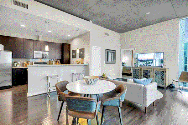 Open kitchen with a breakfast bar for casual dining & modern appliances at Med Center, Houston, TX.
