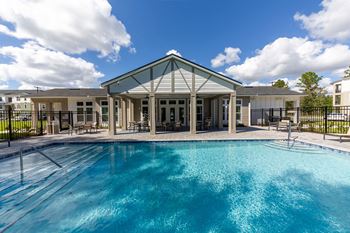 the preserve at ballantyne commons pool and building with a blue pool