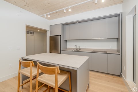 A kitchen with a table and chairs.