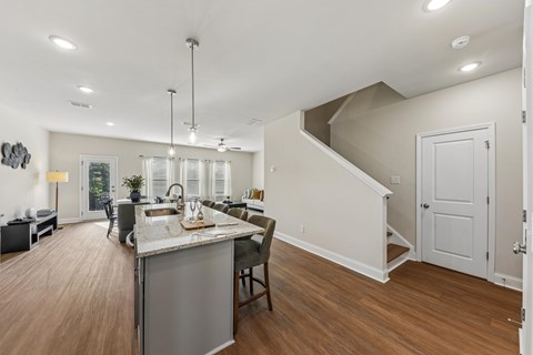 A kitchen with a dining table and chairs is shown.