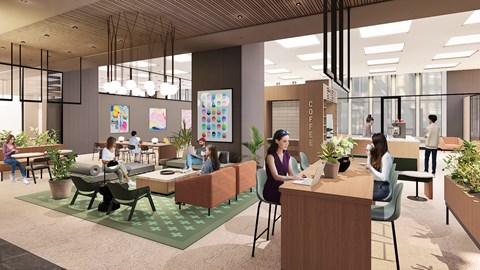 A group of people are sitting and standing in a modern office space.