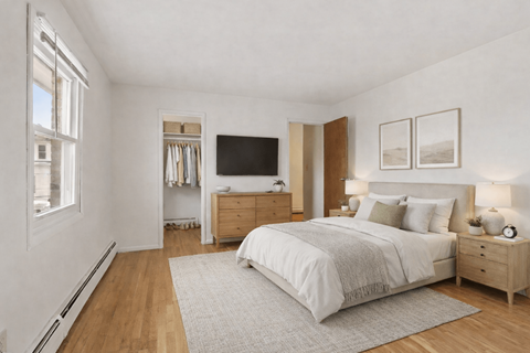 A bedroom with a large bed, a dresser, and a television.