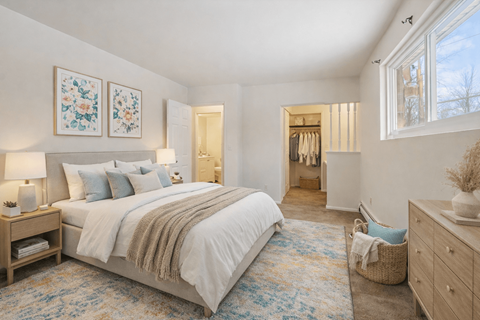 A bedroom with a large bed and a wicker basket on the floor.