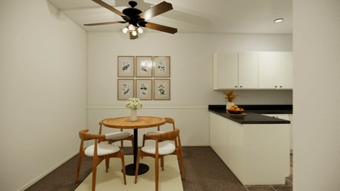 A small dining area with a table and chairs.