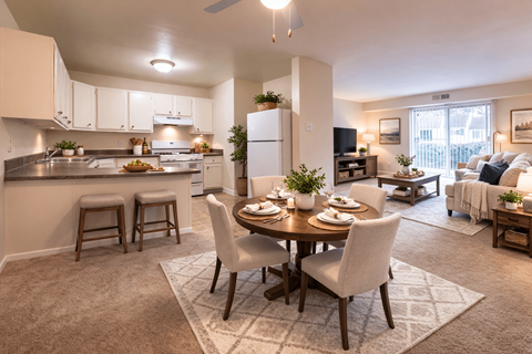 A well-lit, modern kitchen and dining area with a table set for a meal.