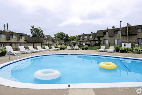A pool with a white and blue border and a yellow and white inner lining.