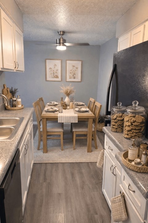 A kitchen with a table set for a meal.