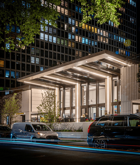A modern building with a glass facade and a white entrance.