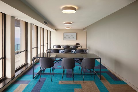 A conference room with a long table and chairs.