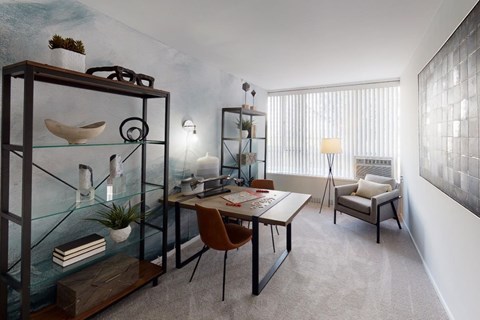 A modern dining room with a glass table and chairs.